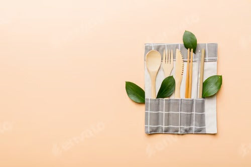 Eco friendly reusable recyclable white eco bag with kitchenware on Colored background