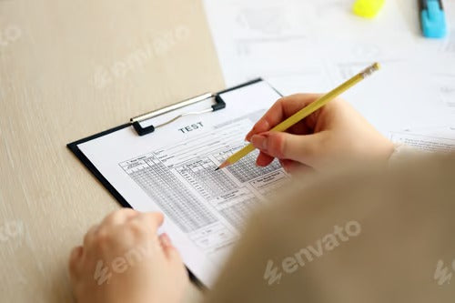 Female student hands testing in exercise and taking fill in exam paper sheet with pencil