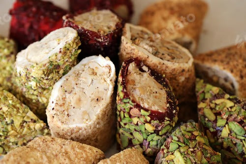 Many rolls of turkish delight with different flavors and fillings close up on table