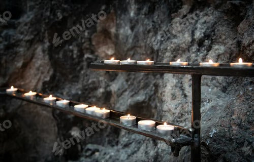 Religious candles glowing with orange flames in a church. Symbols of faith and religion and for