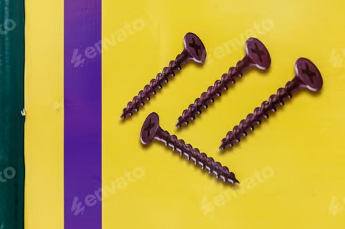 Self-tapping screws on a yellow background