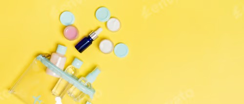 Set of travel size cosmetic bottles on yellow background. Flat lay of cream jars.