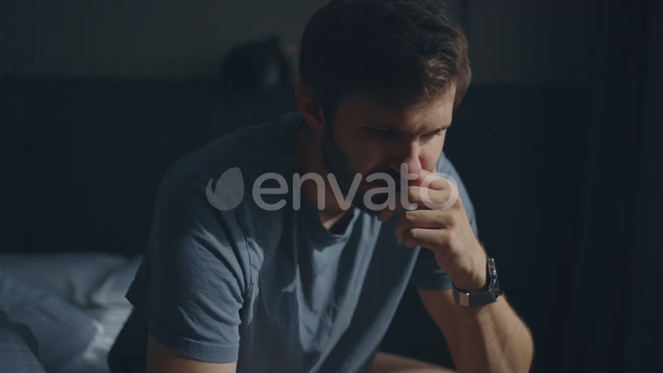 Upset Caucasian Man Sitting on the Bed Thinking About Problem Breakup