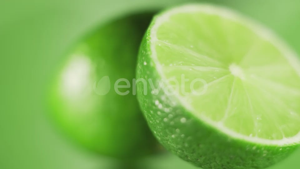 The Fresh Limes are Rotating Slowly on Bright Green Background