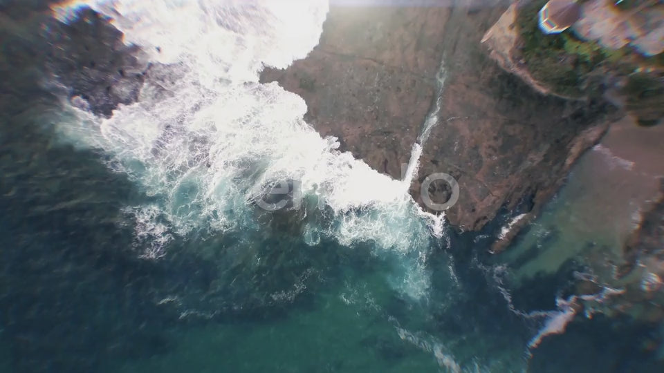 Waves crashing over Californian rocks - birds-eye view.